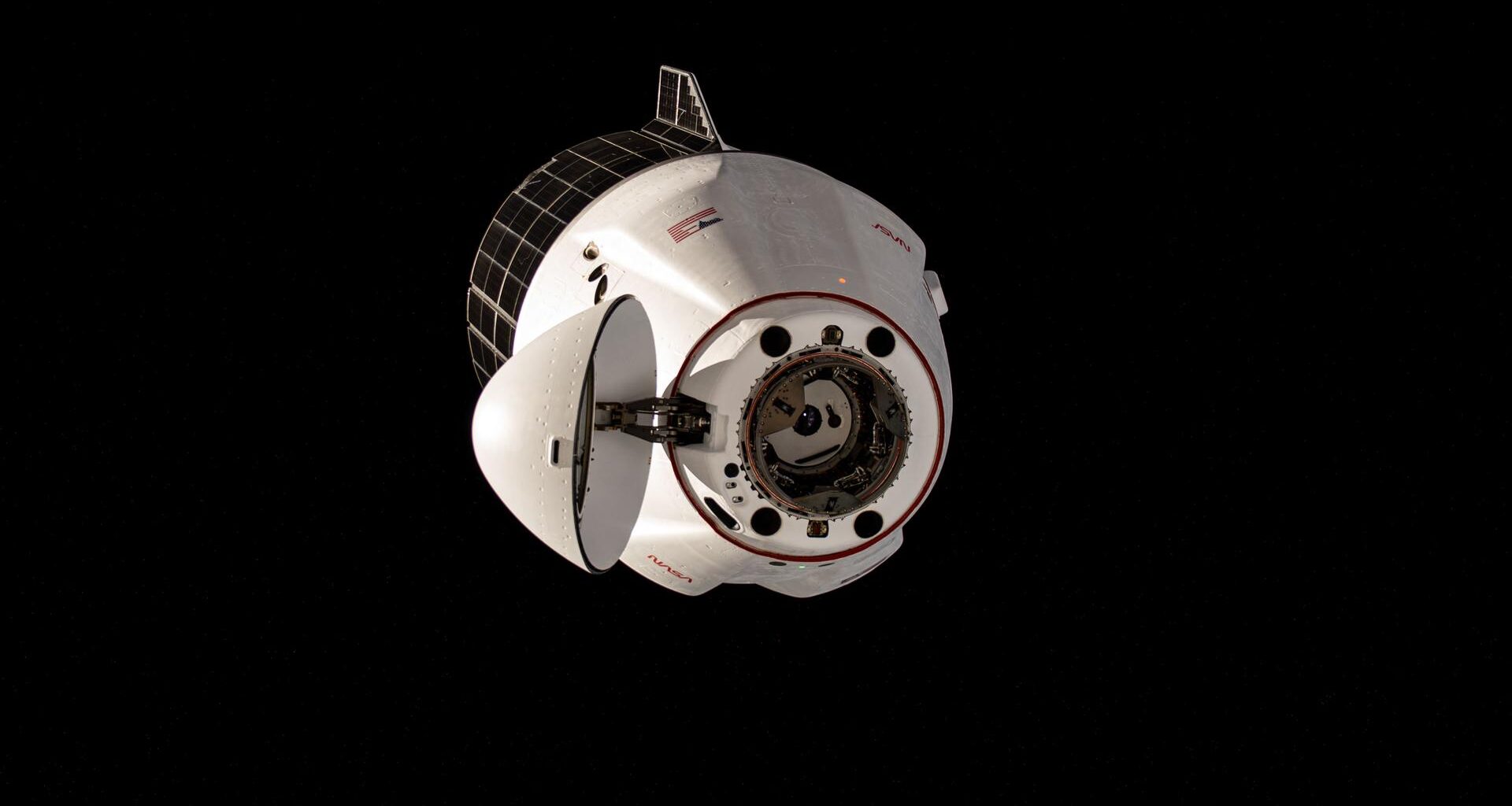 The SpaceX Dragon cargo craft, with its nosecone open, approaches the International Space Station for an automated docking to the Harmony module's space-facing port. Dragon delivered about 6,700 pounds of new science experiments and crew supplies replenishing the Expedition 73 crew.