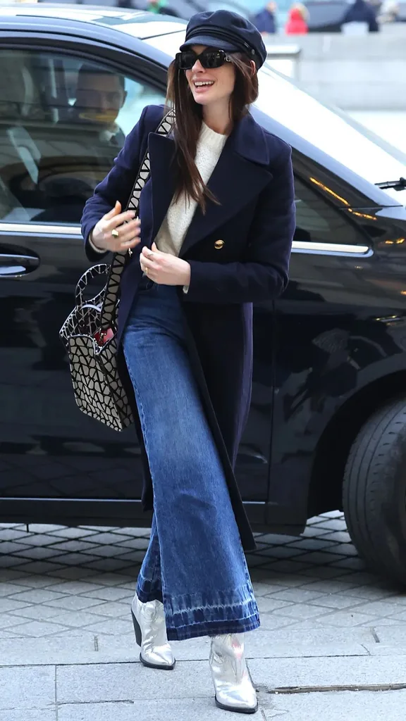 Anne Hathaway wearing  a baker boy cap 