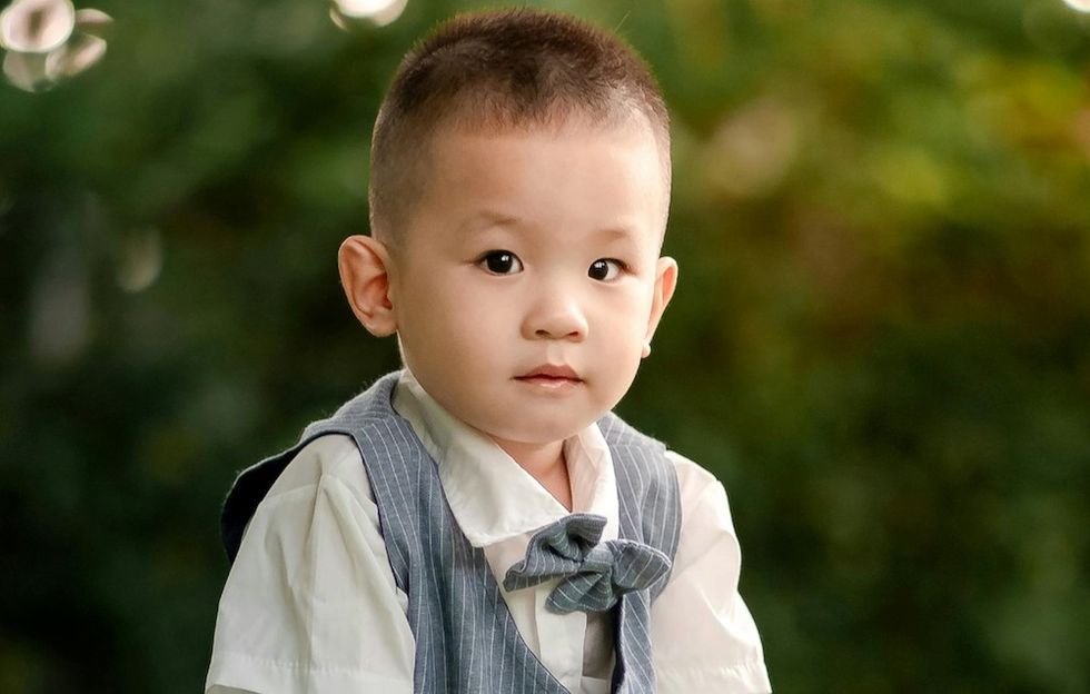 little boy in a vest and a bow tie