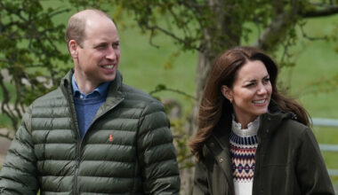 Prince William and Kate Middleton wear matching dark green coats for a walk