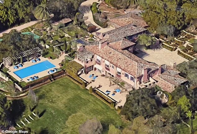 aerial view of a large villa with a swimming pool and landscaped gardens