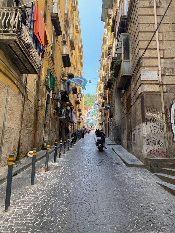 A moped zips through Naples' Spanish Quarter