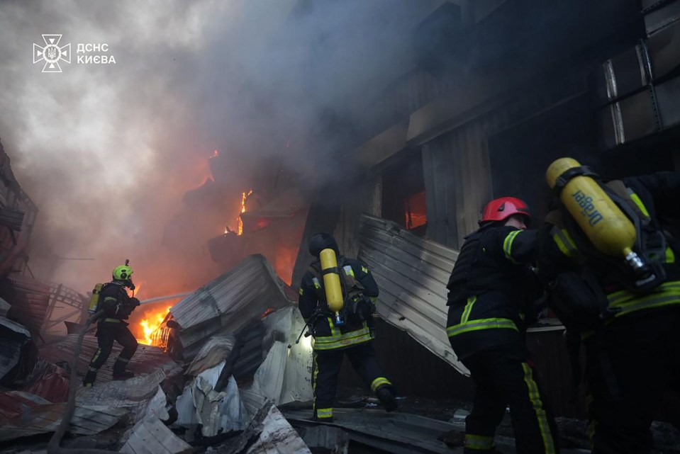 Firefighters battling a large fire in Kyiv.