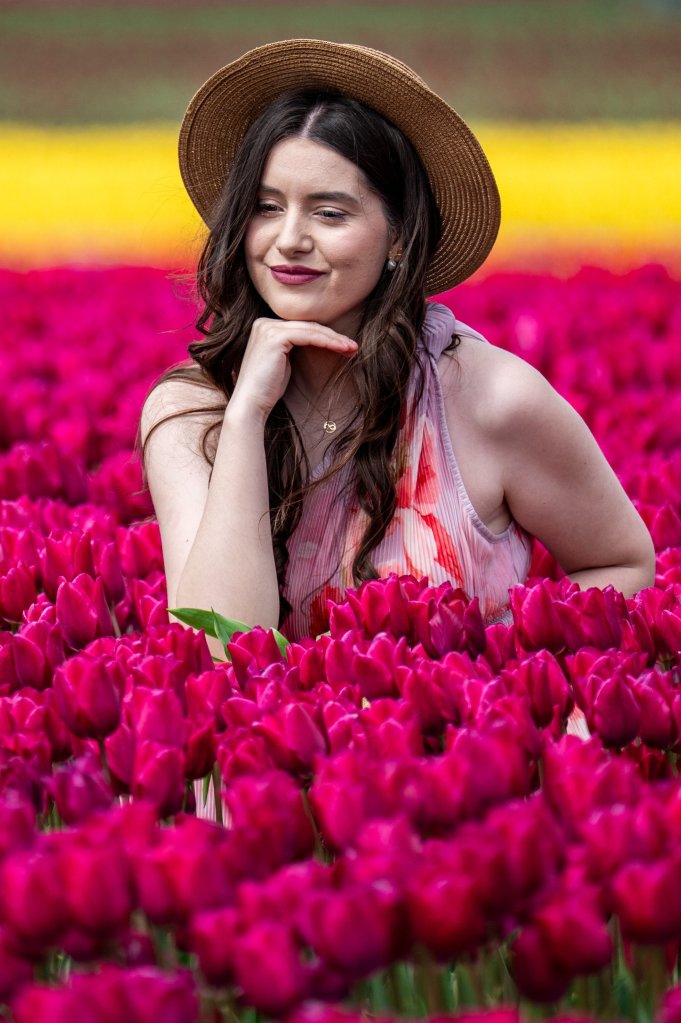 girl posing in field of tulips
