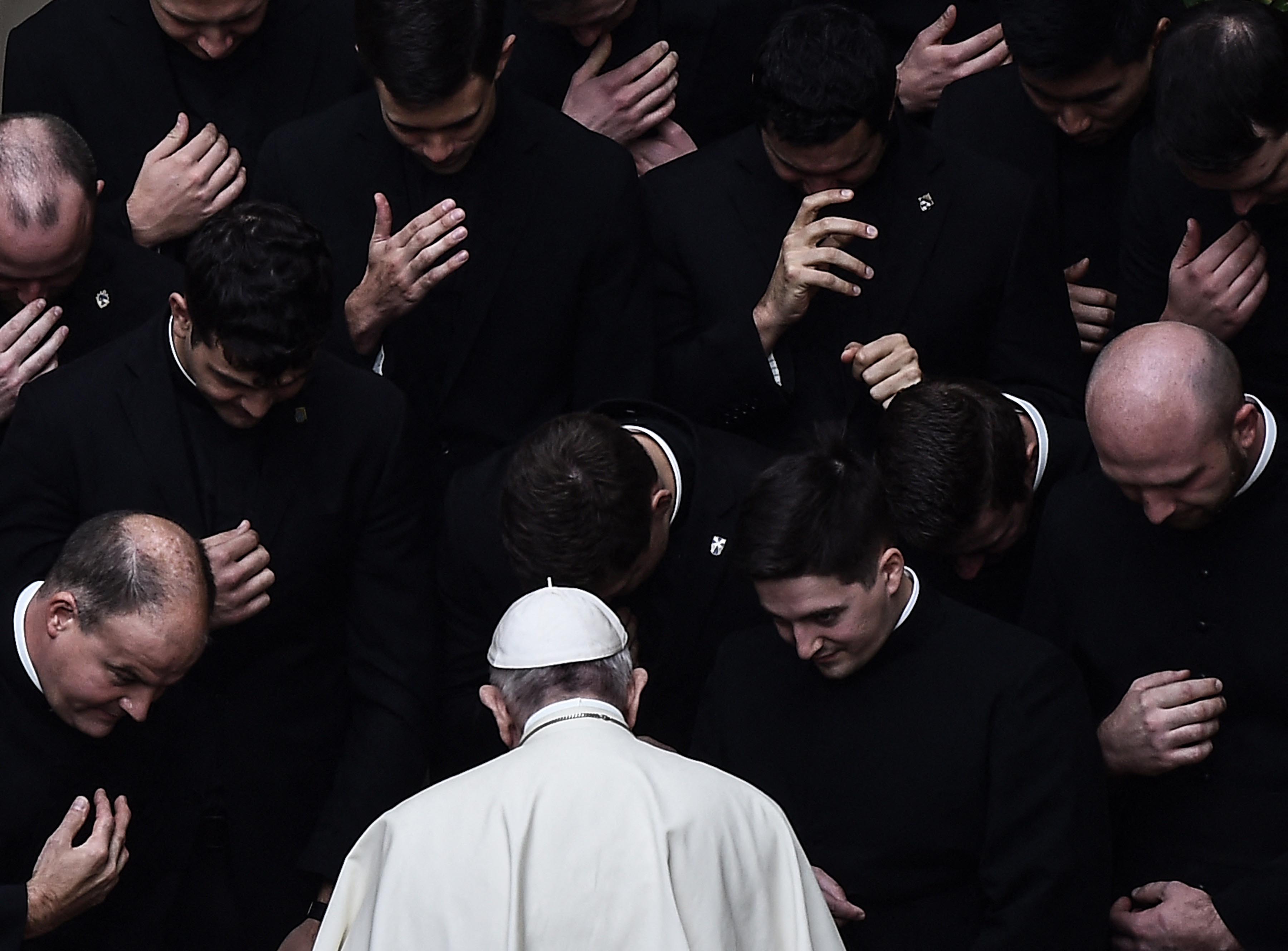 Pope Francis prays with priests at the end of a limited public audience at the Vatican during the Covid pandemic