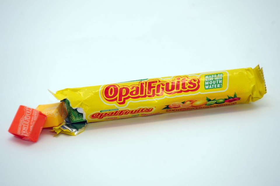 A partially opened packet of Opal Fruits candies.