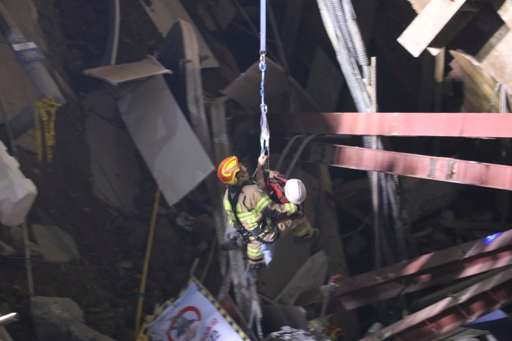 Rescue workers pulled a man from a collapsed subway construction site on Saturday.