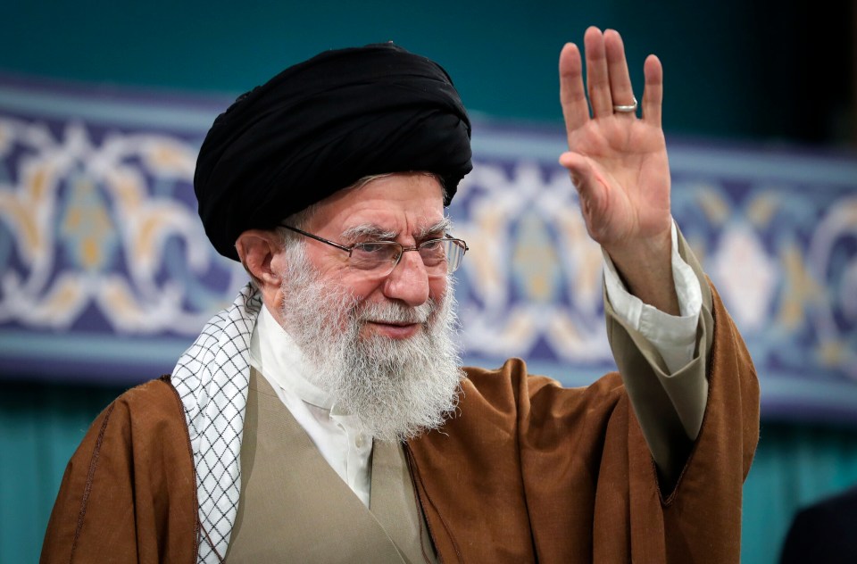 Ayatollah Ali Khamenei waving to a crowd.