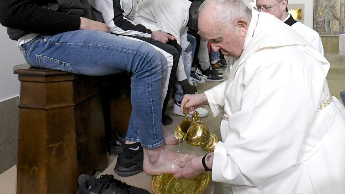 Pope Francis washes the feet of a prisoner