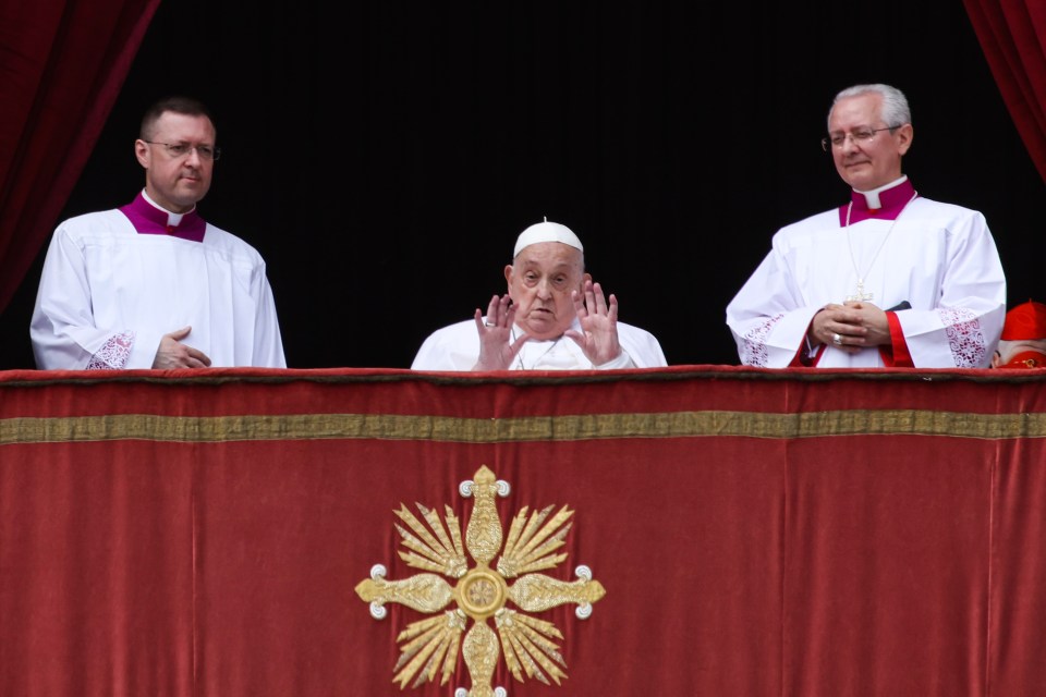 Pope Francis giving a blessing from a balcony.