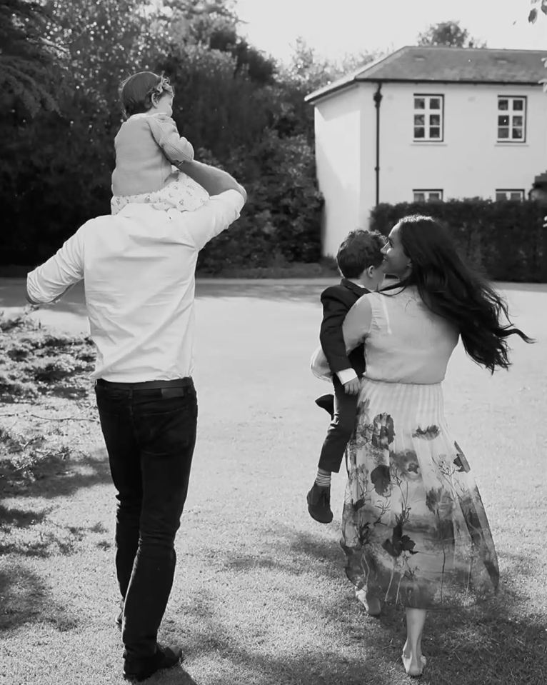 Black and white photo of Prince Harry and Meghan Markle with their children, Archie and Lilibet.