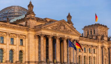 Die deutsche und die europäische Flagge wehen vor dem Reichstagsgebäude in Berlin.