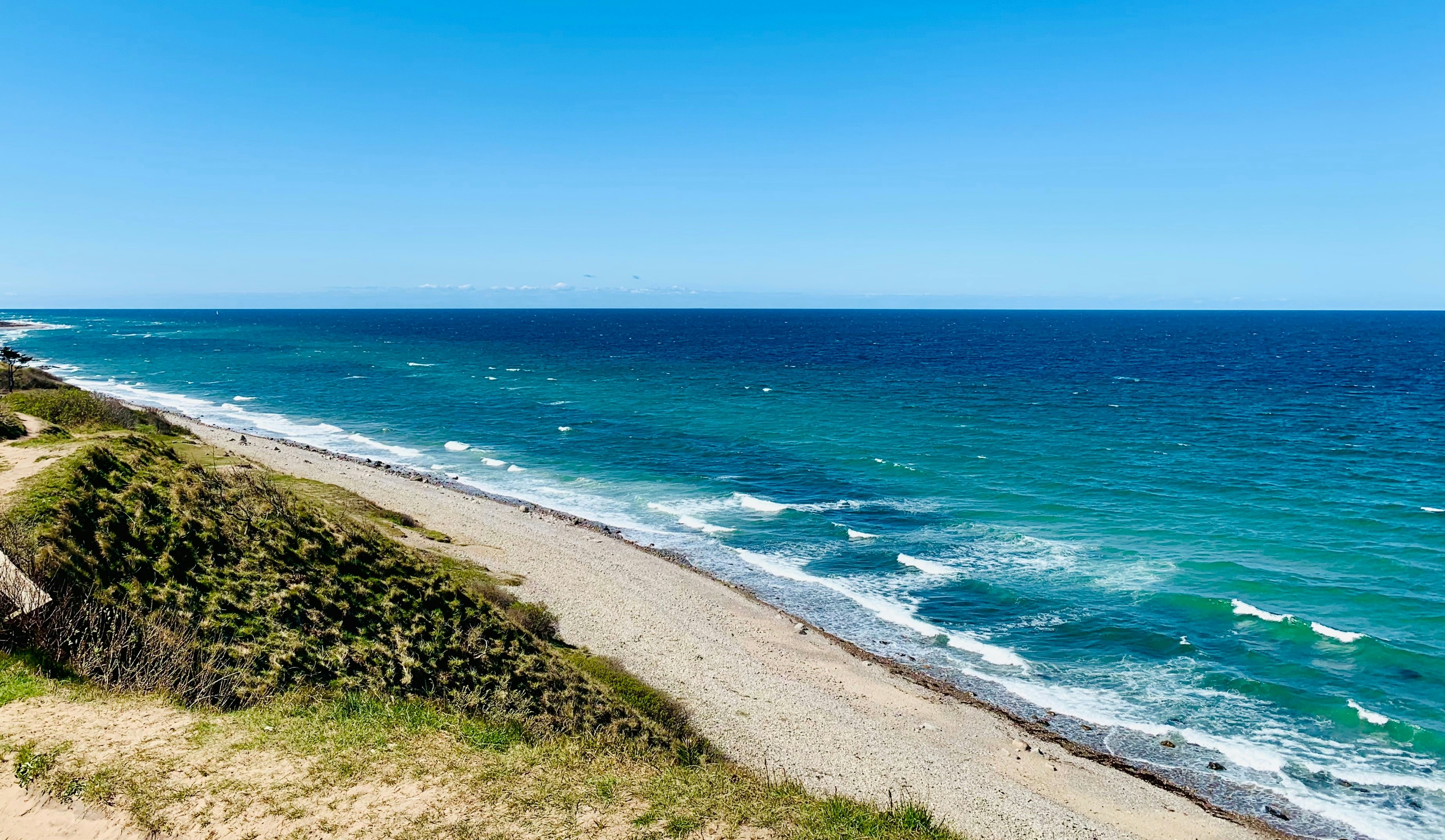 A sandy beach lapped by the surf