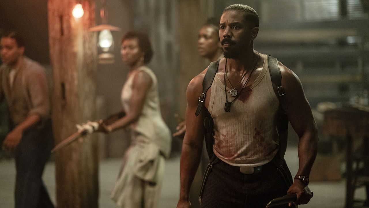 This image released by Warner Bros Pictures shows Michael B. Jordan, right, in a scene from "Sinners." (Warner Bros. Pictures via AP)