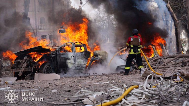 Firefighters work at the site of a Russian missile strike in Sumy on Sunday. Pic: Reuters