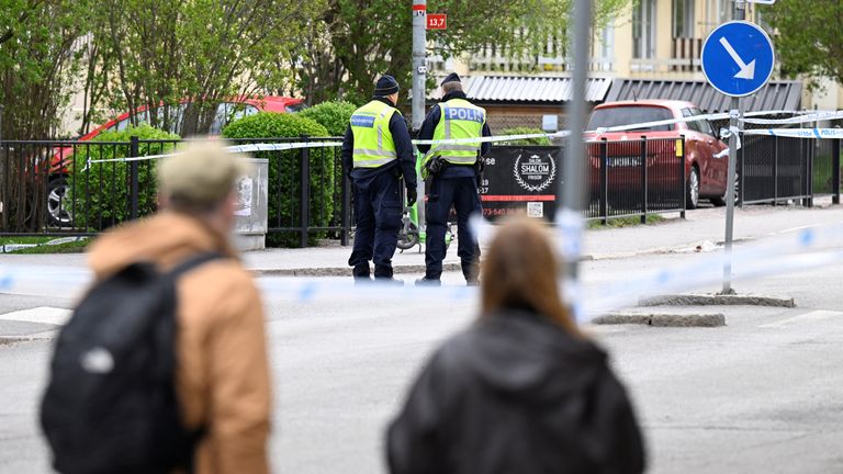 Police officers work on-site a day after a deadly shooting, at Vaksala Square, in Uppsala, Sweden.
Pic: TT News Agency/Reuters