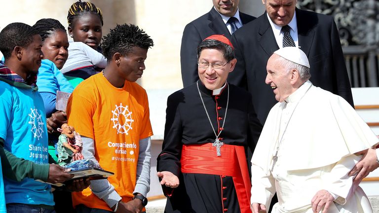 Pope Francis meets Cardinal Luis Antonio Tagle and a group of migrants in Saint Peter’s Square at the Vatican in this file photo from September 2017. Cardinal Tagle is considered among the possible successors to the late pope and has even been referred to as “the Asian Francis” by some Catholic commentators. Pic: Reuters