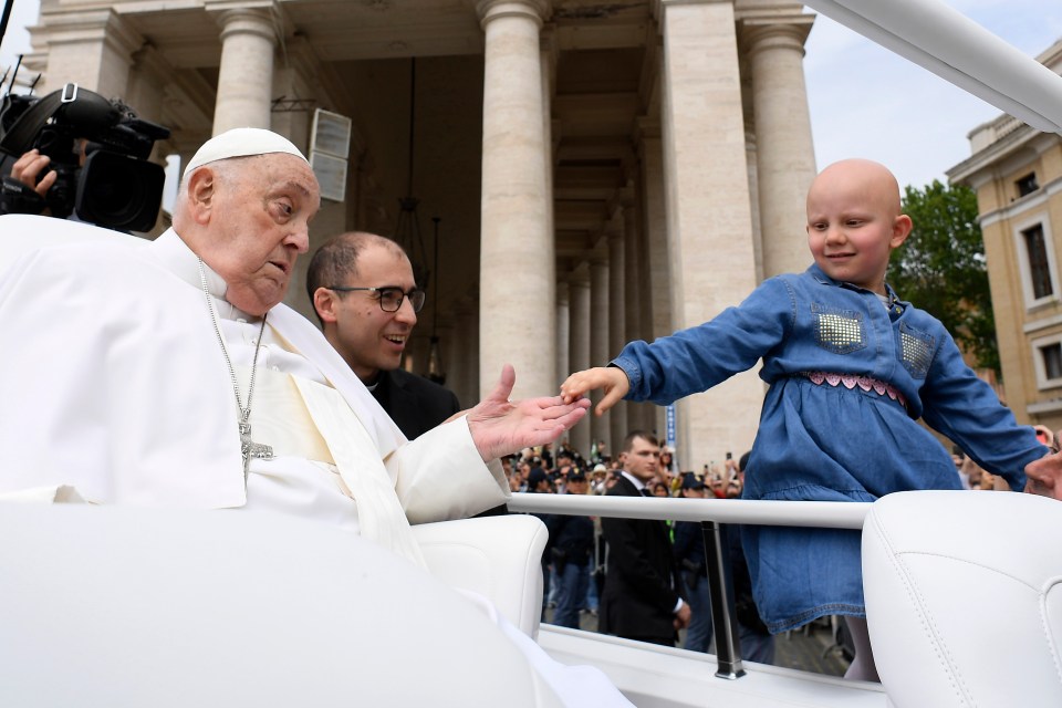 Pope Francis greeting a young girl at Easter Mass.