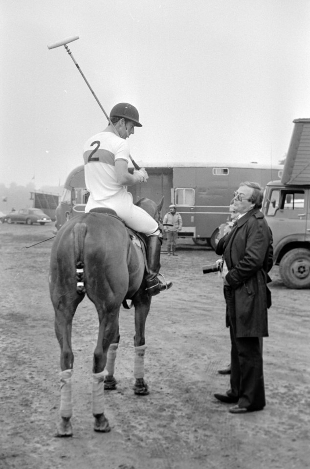 Prince Charles playing polo, speaking with a photographer.