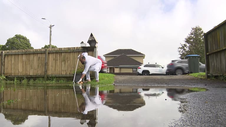 Syed Shagi cleaning the aftermath of the floods on his property.
