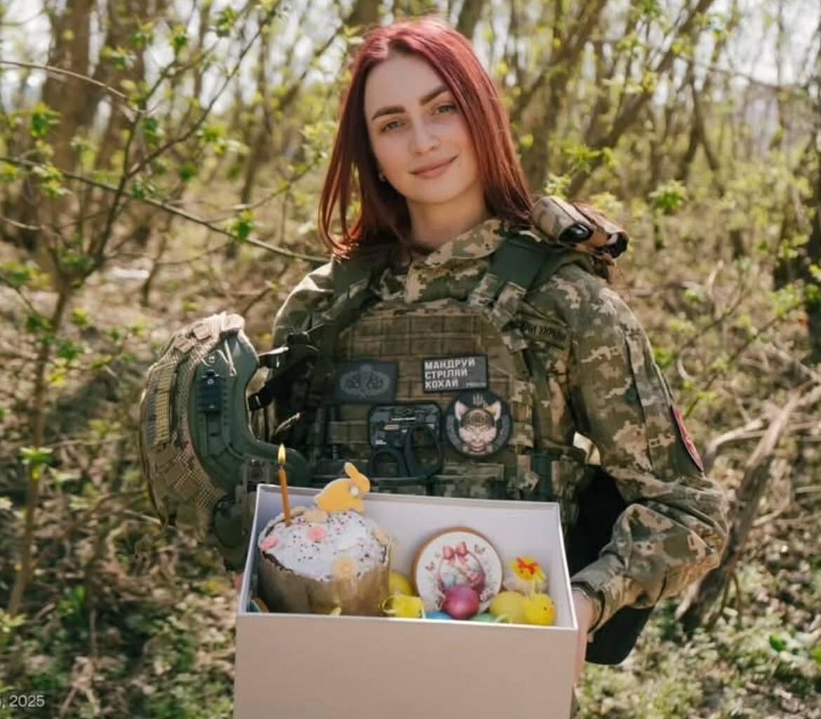 Ukrainian soldier with a patch that says (Маріупольський Коти) (Mariupol Cats) - from the Ukrainian Army - on Easter Sunday - with a box of decorated Easter eggs.