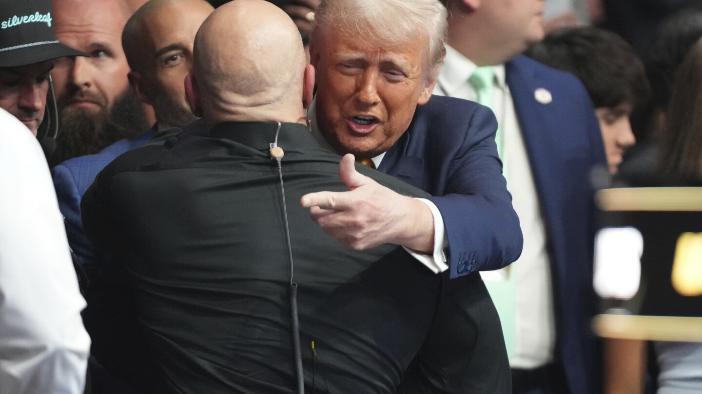 Trump receives a standing ovation as he enters a UFC event in Miami