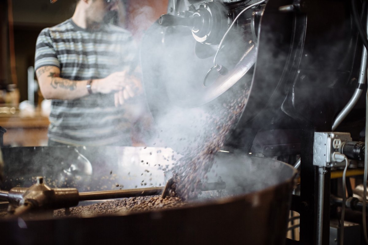 A Wonderstate Coffee worker operating a roaster