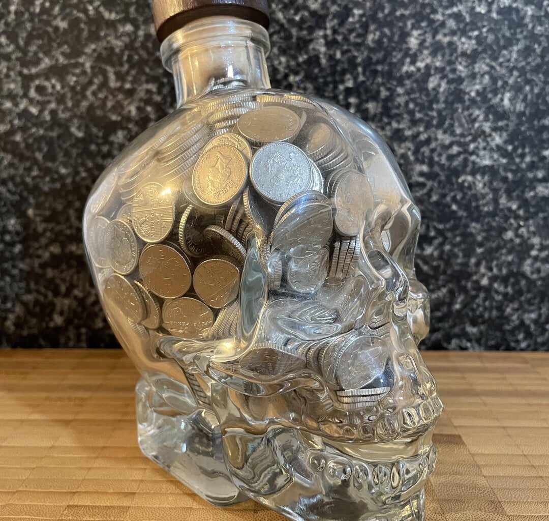I’ve been using a Crystal Skull Vodka bottle to collect 5ps for over a decade. Today I finally finished. How much do you think is in it?