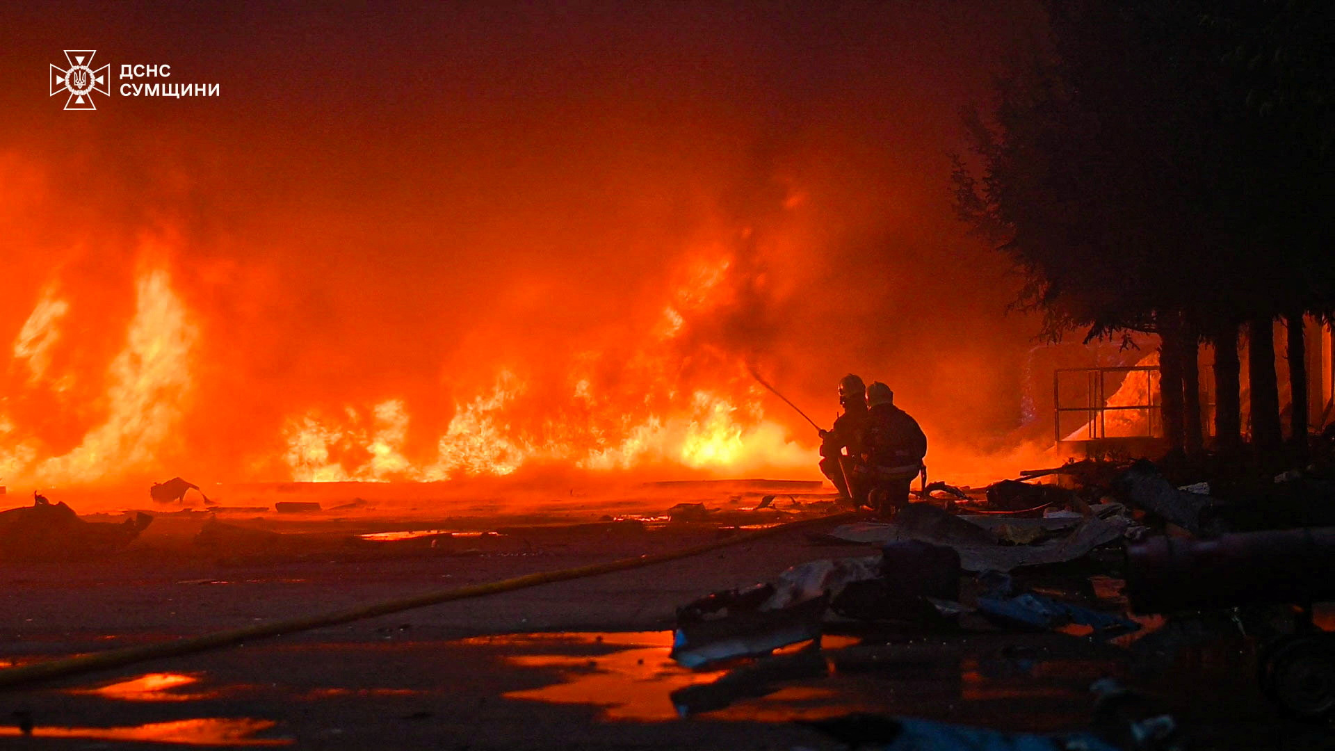 Firefighters at the site of a business hit by a Russian drone strike in Sumy, northeastern Ukraine, on Thursday