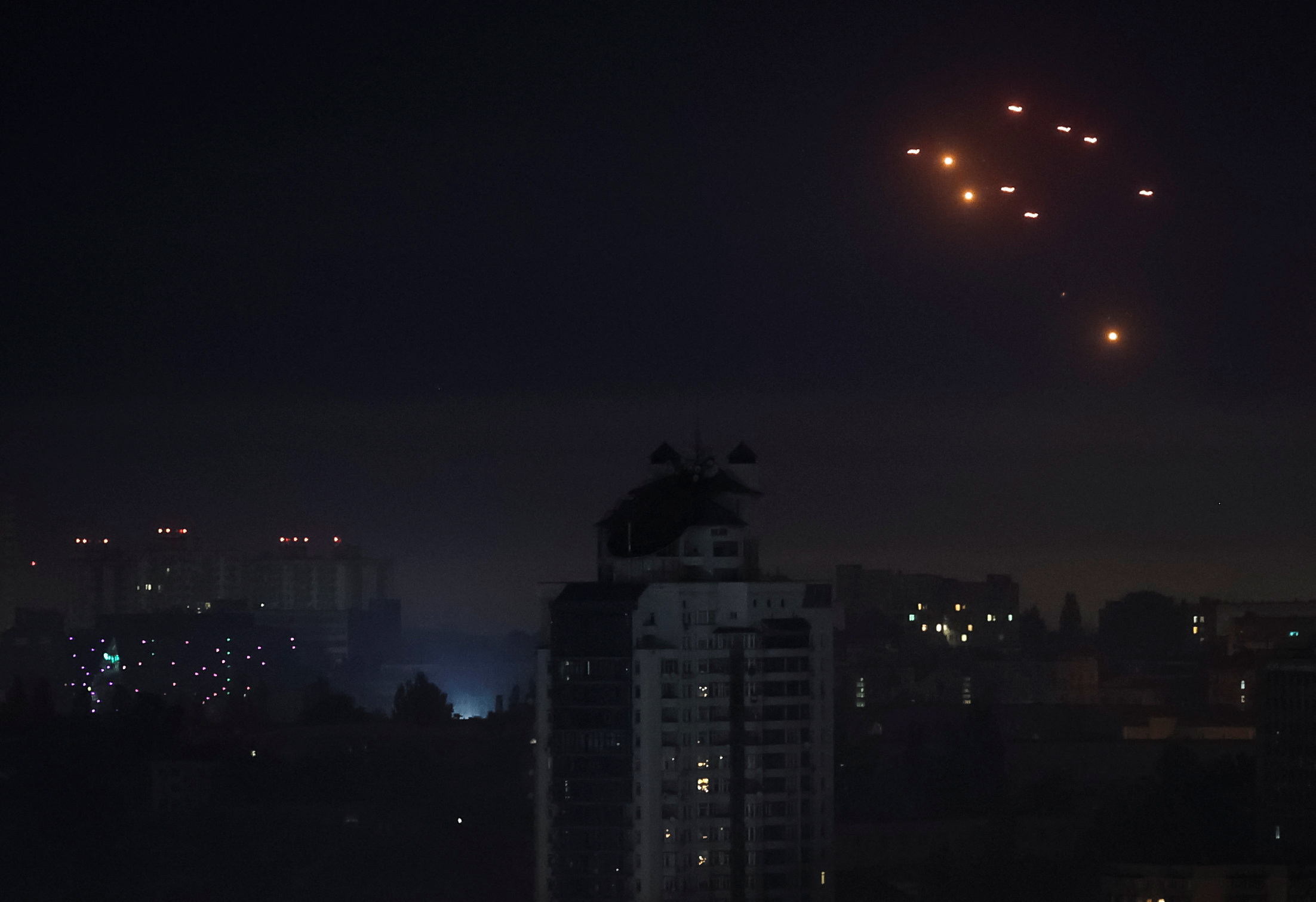 Explosions in Kyiv night sky during a Russian drone strike.