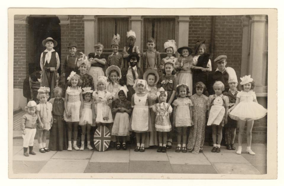 Postcard of children's V.E. (Victory in Europe) day party and celebrations, parties were held to celebrate the end of the 2nd world war in Europe - the children are in fancy dress, at Cornwall Grove, Chiswick, London,U.K. 8 May 1945 (Marking the end of WWii), wartime memories.