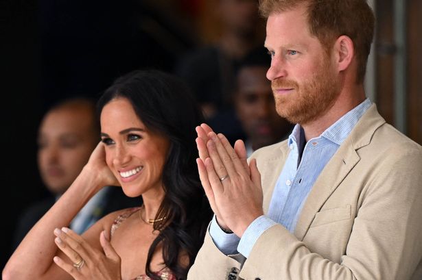 Britain's Prince Harry (C), Duke of Sussex, and his wife Meghan Markle react while attending a show during a visit to the National Centre for the Arts in Bogota on August 15, 2024