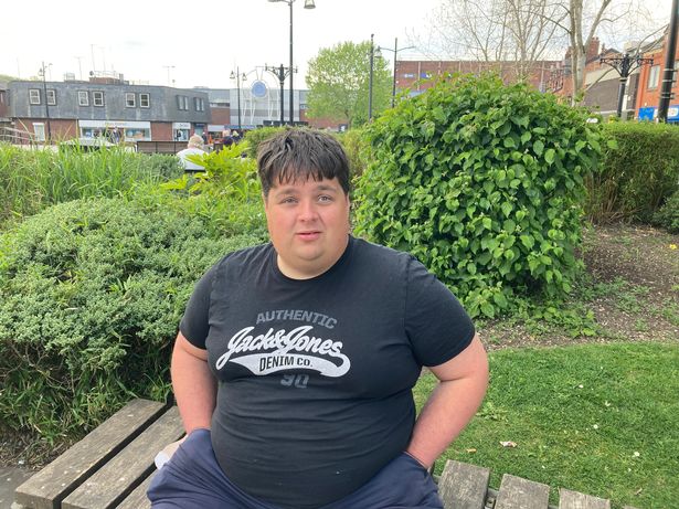 Ashley Wakefield, sitting in Middleton town centre