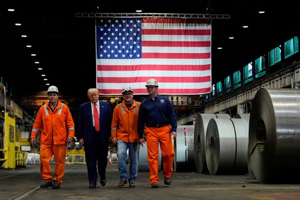 President Donald Trump walks with workers as he tours U.S. Steel Corporation's Mon Valley Works-Irvin plant