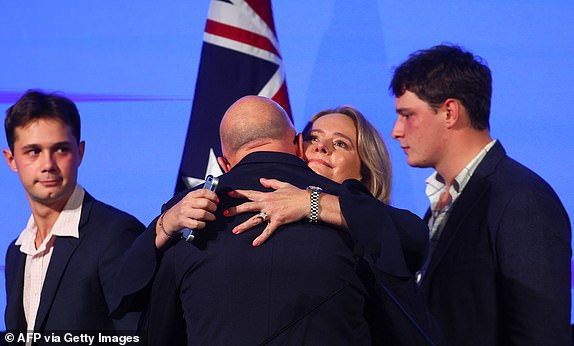 Australia's Opposition Leader Peter Dutton is hugged by his wife Kirilly Dutton beside their sons Tom and Harry after he conceded defeat in the general election at the Liberal Party election night event in Brisbane on May 3, 2025. Australia's right-leaning opposition leader Peter Dutton conceded defeat in a general election on May 3, saying he had spoken to Prime Minister Anthony Albanese. (Photo by Patrick Hamilton / AFP) (Photo by PATRICK HAMILTON/AFP via Getty Images)