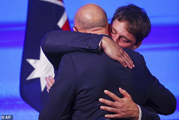 Australian Liberal Party leader Peter Dutton is embraced by his son Harry after making his concession speech following the general election in Brisbane, Australia, Saturday, May 3, 2025. (AP Photo/Pat Hoelscher)