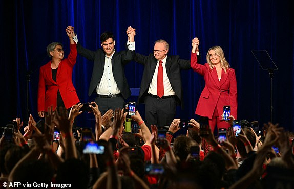 TOPSHOT - Australia's Prime Minister Anthony Albanese celebrates with his partner Jodie Haydon (R), son Nathan Albanese and Australia's Foreign Minister Penny Wong (L) after winning the general election at the Labor Party election night event in Sydney on May 3, 2025. Left-leaning Prime Minister Anthony Albanese triumphed on May 3 in Australia's general election, according to media projections, prevailing in a vote shaped by inflation woes and Trump tariffs. (Photo by Saeed KHAN / AFP) (Photo by SAEED KHAN/AFP via Getty Images)