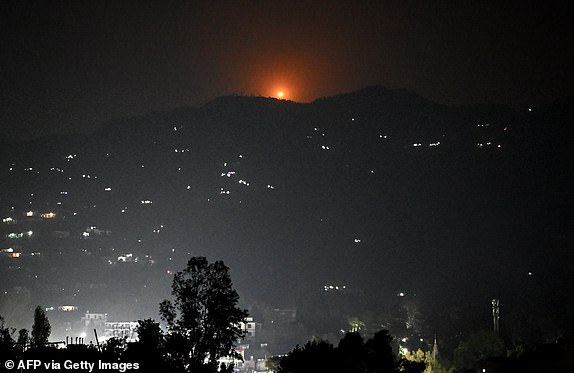 A flare goes up in air over the hill near main town of Poonch district, on May 7, 2025. India said on May 7 it carried out "precision strikes at terrorist camps" inside Pakistan and Pakistani-controlled Kashmir, days after it blamed Islamabad for a deadly attack on the Indian side of the contested region. (Photo by Punit PARANJPE / AFP) (Photo by PUNIT PARANJPE/AFP via Getty Images)