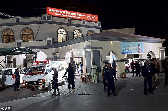 Security officials stand guard as an ambulance arrives with people injured by a suspected Indian missile attack, at a hospital in Bahawalpur, Pakistan, Wednesday, May 7, 2025. (AP Photo/Asim Tanveer)