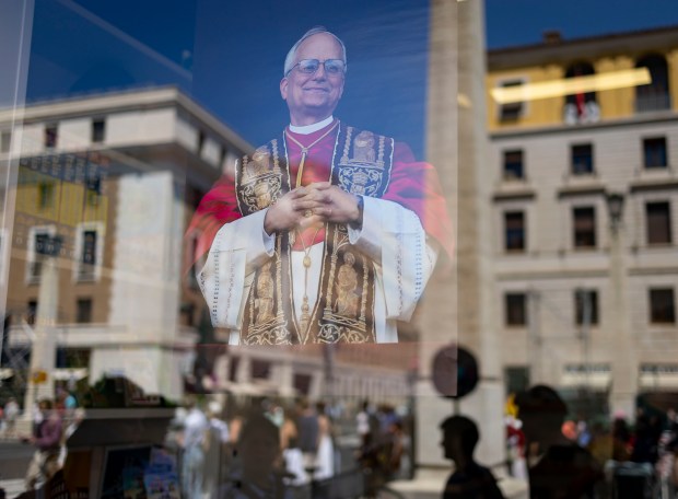 A photo of Pope Leo XIV is displayed in a...