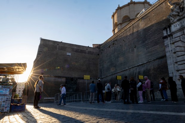 Tourists line up to enter the Vatican Museums on May...