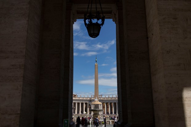 People visit St. Peter’s Square on Friday, May 16, 2025,...