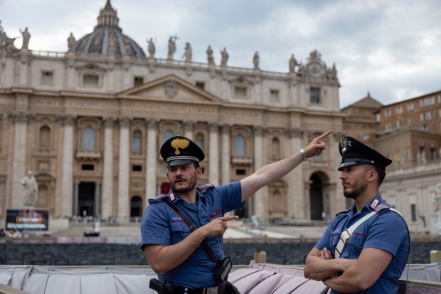 Italian Carabinieri direct tourists around St. Peter’s Square on Thursday,...