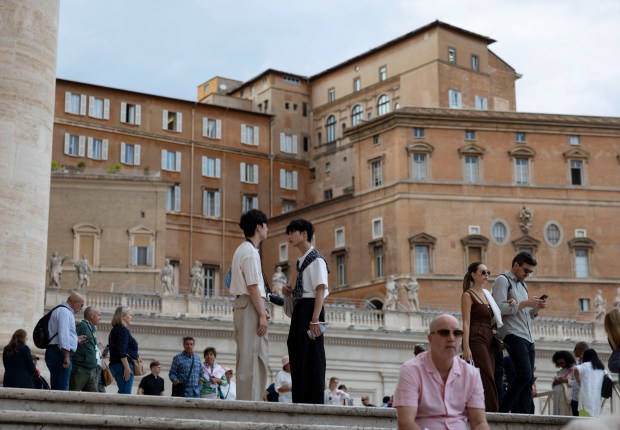 People visit St. Peter’s Basilica on Thursday, May 15, 2025,...