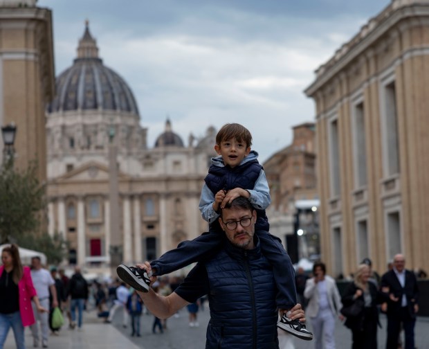 People visit St. Peter’s Square on Thursday, May 15, 2025,...