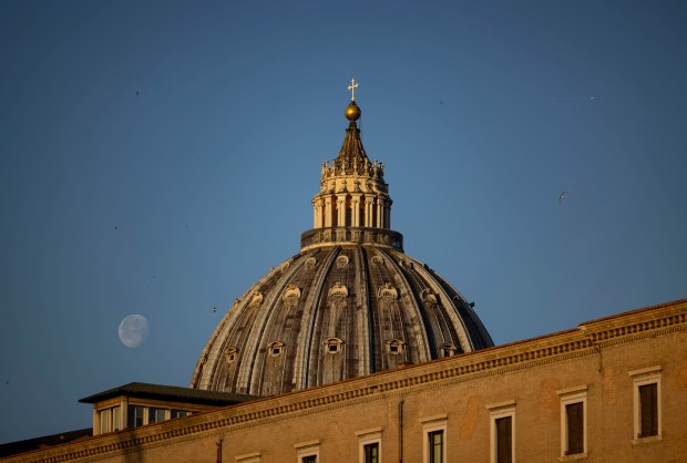 The moon next to St. Peter’s Basilica on May 16,...