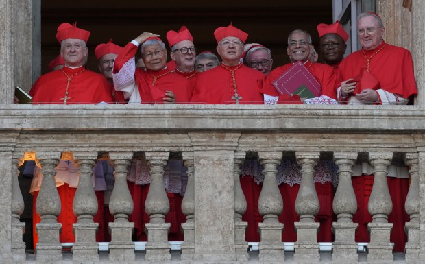 Cardinals, including Chicago Cardinal Blase Cupich at left, appear at the Vatican on May 8, 2025, after the election of Cardinal Robert Prevost as the 267th pope. He chose the name Pope Leo XIV. (Andrew Medichini/AP)