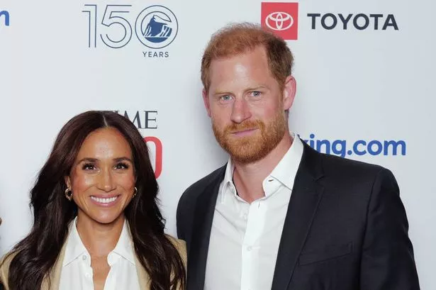 Meghan Markle, in a beige suit, and Prince Harry, in a dark suit, at an event in 2025.