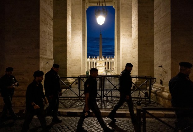 Security officers arrive before dawn in St. Peter's Square s Pope Leo XIV is installed during Mass on May 18, 2025, at the Vatican. (Brian Cassella/Chicago Tribune)