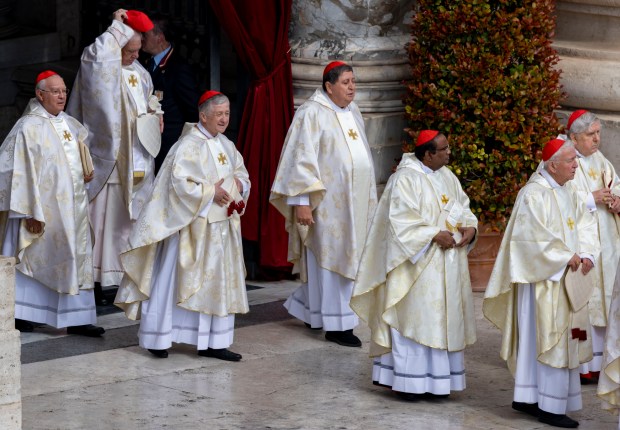 Cardinal Blase Cupich, third from left, arrives with the other cardinals as Pope Leo XIV is installed during Mass in St. Peter's Square on May 18, 2025, at the Vatican. (Brian Cassella/Chicago Tribune)